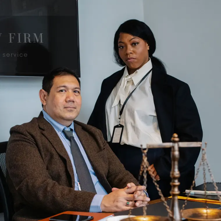Two associates reviewing case documents at a conference table