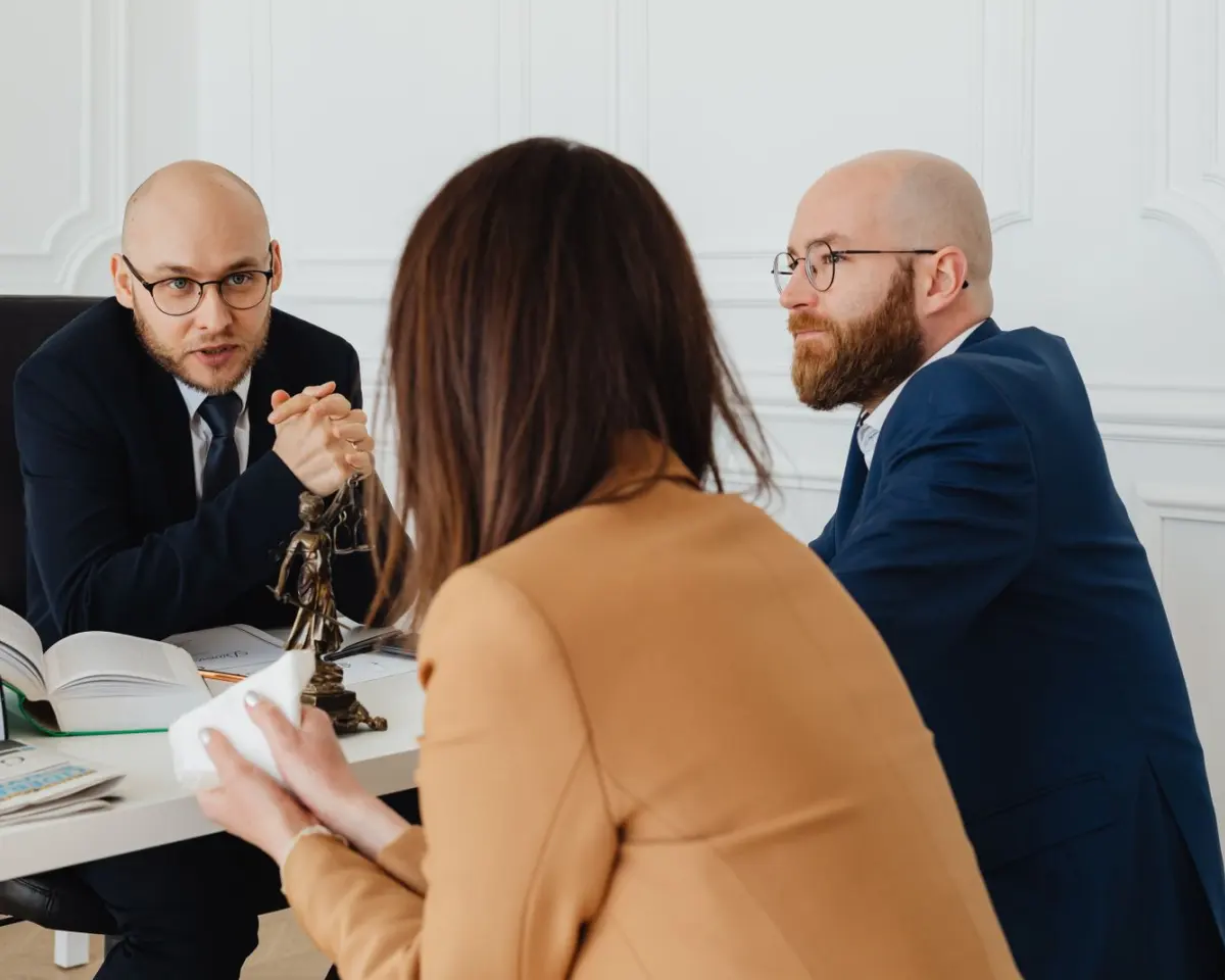 An attorney explaining documents to a client across a desk