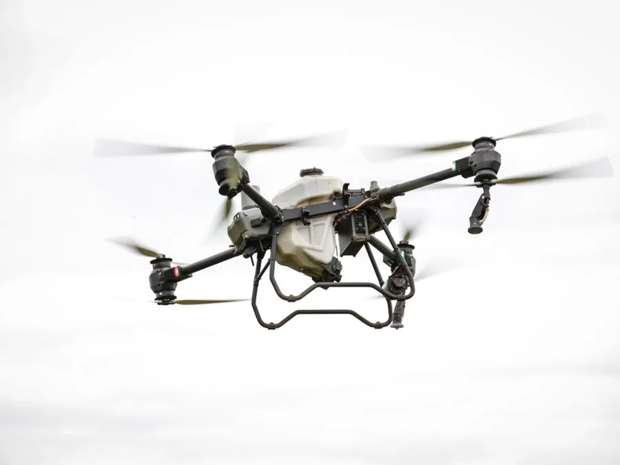 Survey drone hovering above farmland