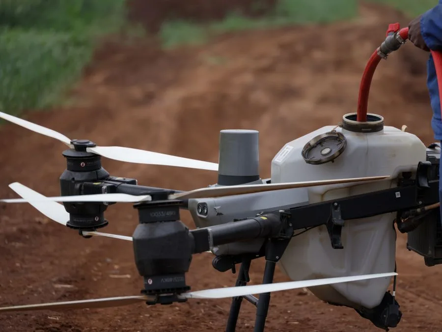 Ground crew filling an agricultural drone tank