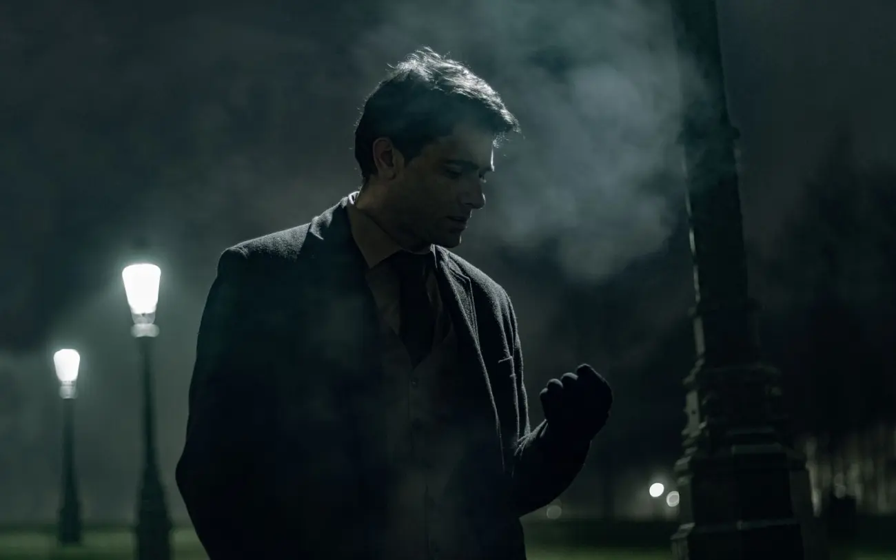 Still from Nine Winters: a figure silhouetted between lamp posts in fog