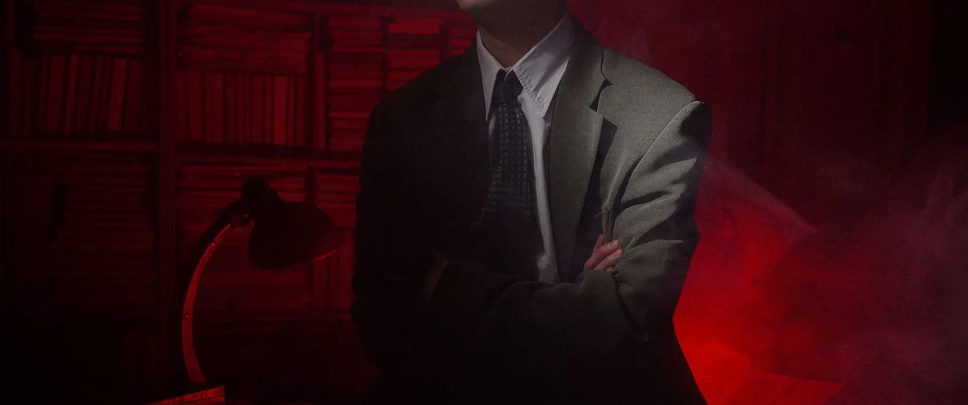 A figure held in red light and smoke