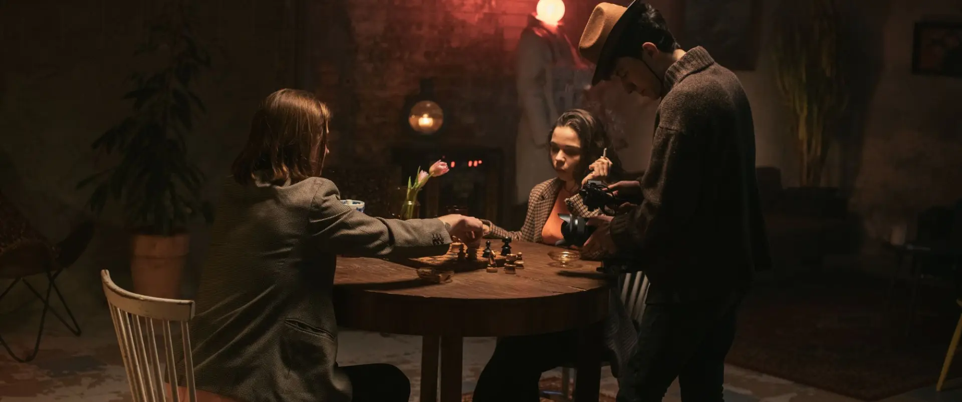 Three players around a card table in a dim period bar