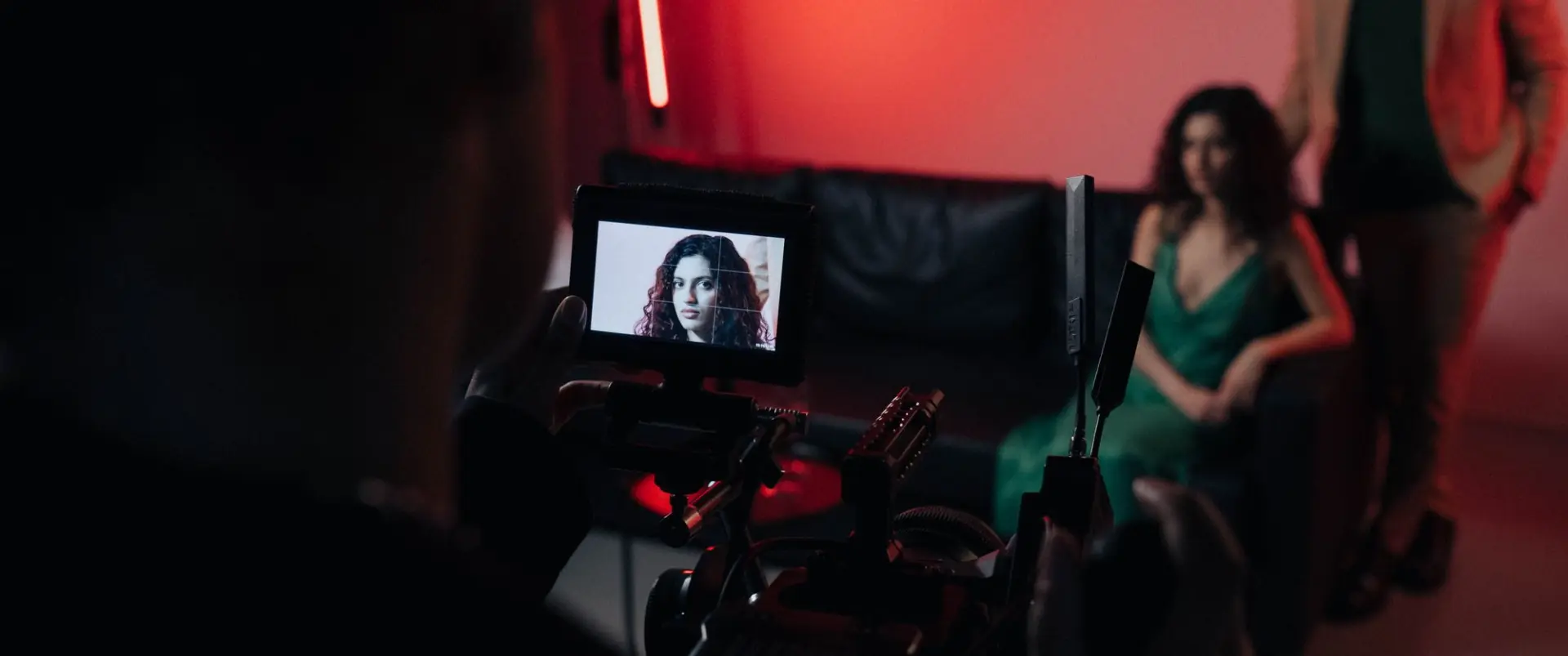 An operator framing a scene from behind the lights