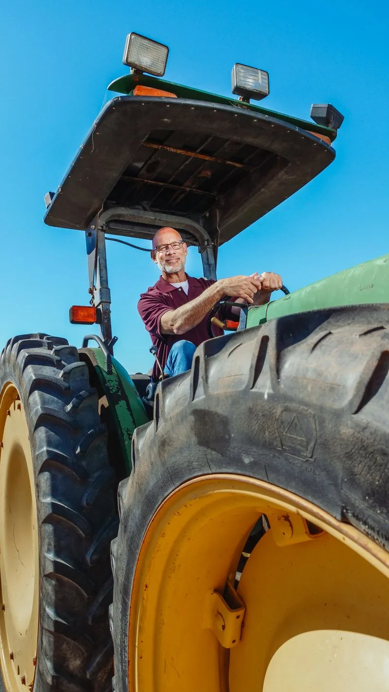 A tractor working the farm under an open sky