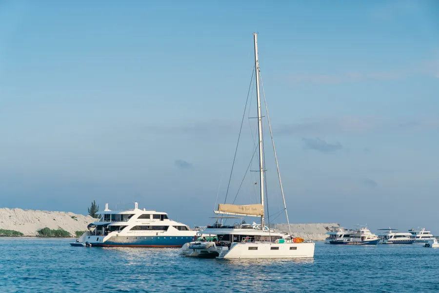 Yachts moored on clear water near the shore