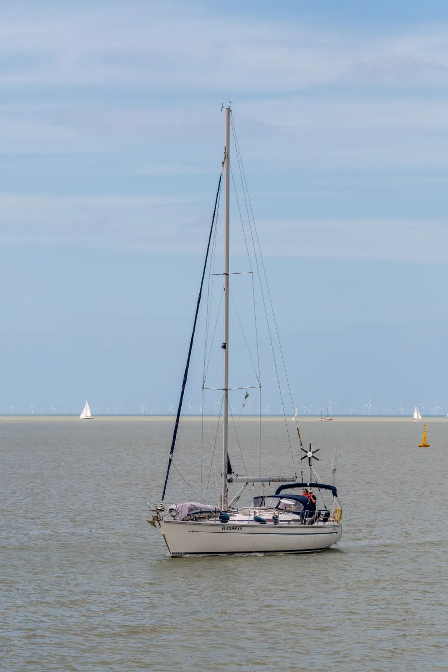 A sailing boat gliding across still water