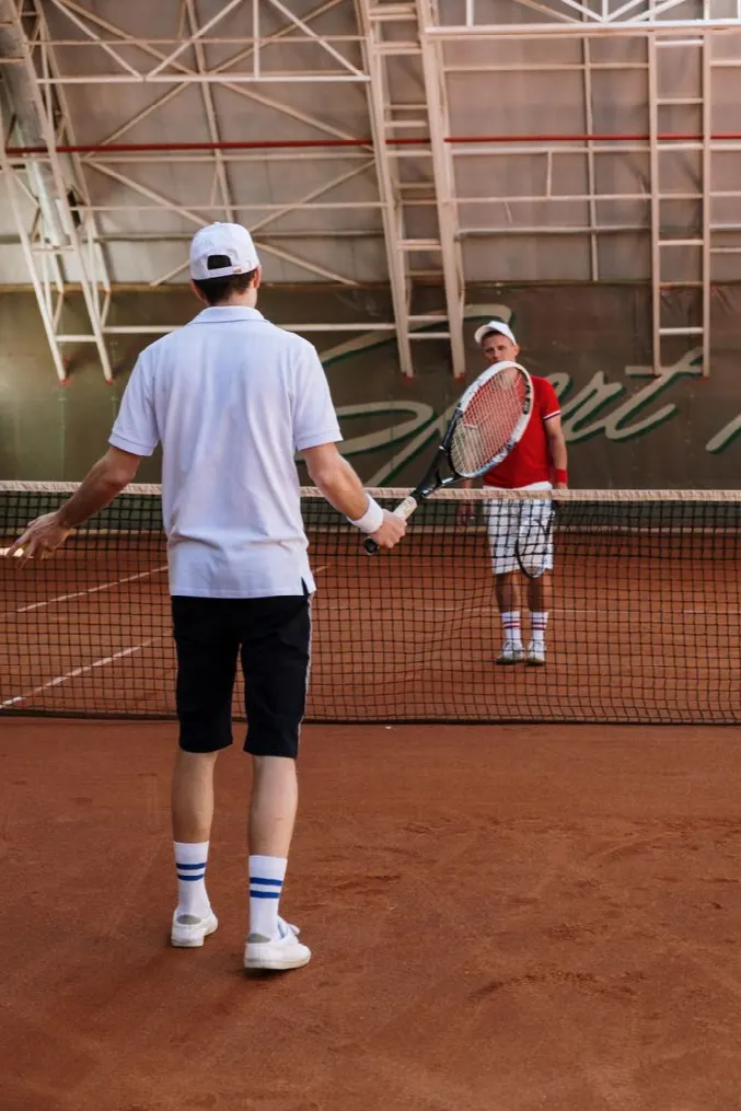 Two players rallying on a covered clay court