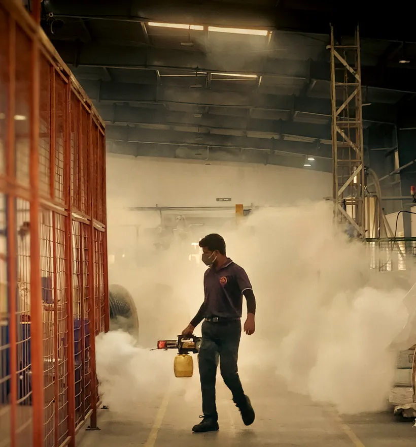 Technician carrying out a scheduled treatment inside a commercial space